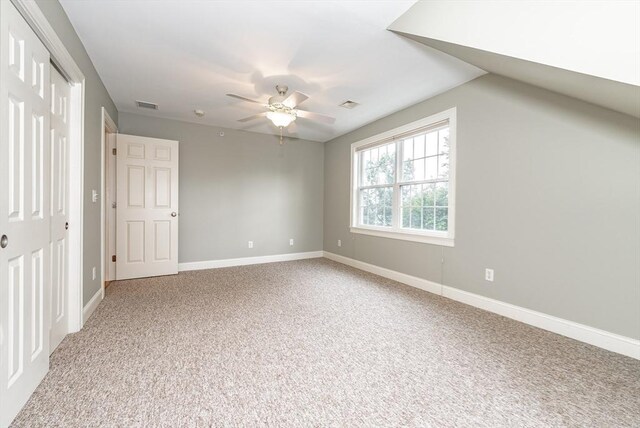 interior space with carpet flooring, lofted ceiling, and ceiling fan