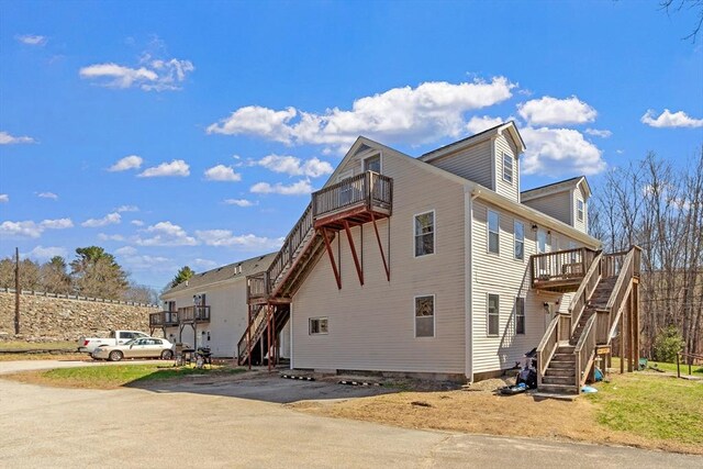 44 Howarth Rd, Oxford, MA 01540 - view of property exterior featuring stairs, a balcony, and a deck