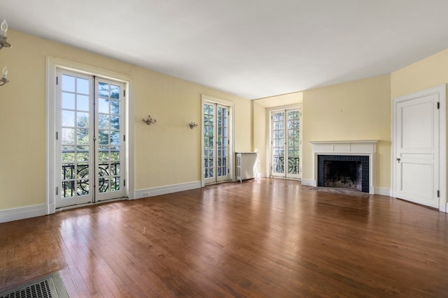 unfurnished living room featuring hardwood / wood-style floors and a fireplace