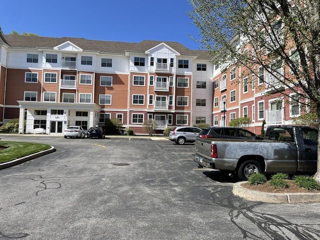 view of building exterior with uncovered parking