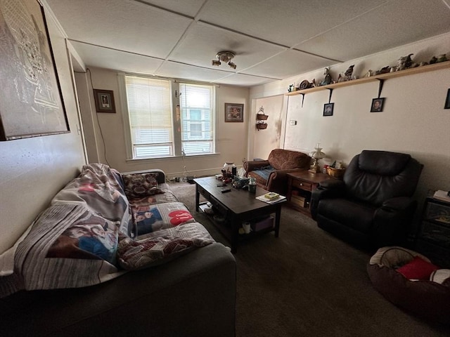 carpeted living area featuring a paneled ceiling
