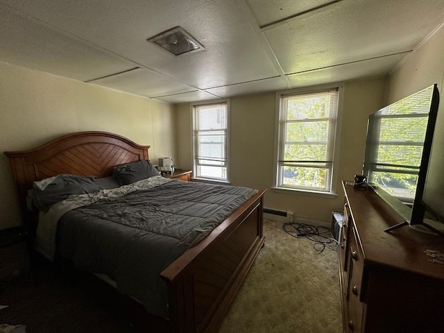 bedroom with a baseboard radiator and carpet floors