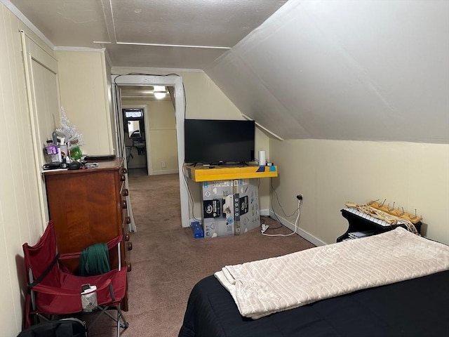 carpeted bedroom with lofted ceiling and baseboards
