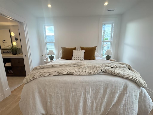 8A Milk St Unit 1, Newburyport, MA 01950 - bedroom with multiple windows, light wood-style floors, and recessed lighting