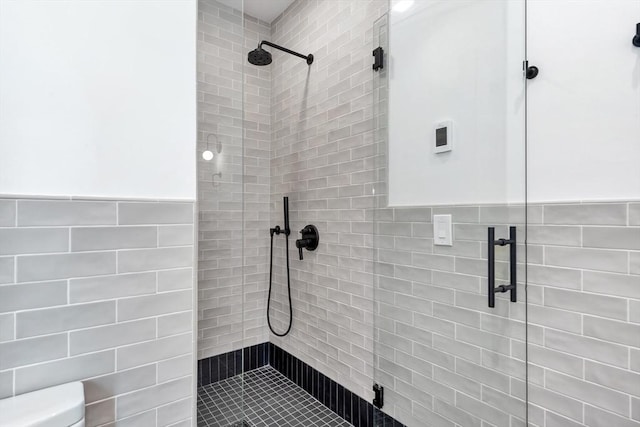 8A Milk St Unit 1, Newburyport, MA 01950 - full bathroom with tile walls, a tile shower, and a wainscoted wall
