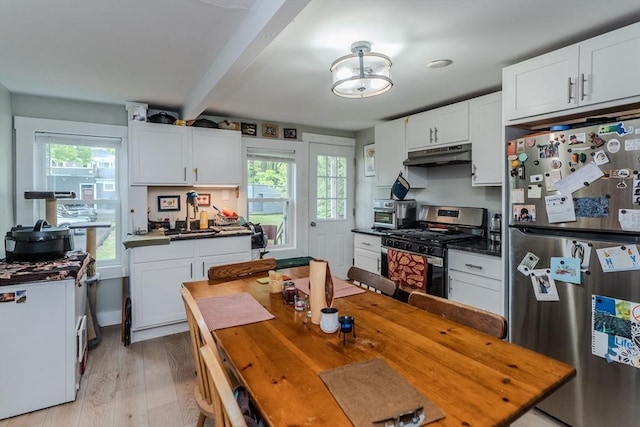16 Fairfield Ave, Northampton, MA 01062 - kitchen with appliances with stainless steel finishes, under cabinet range hood, beamed ceiling, plenty of natural light, and light wood-type flooring