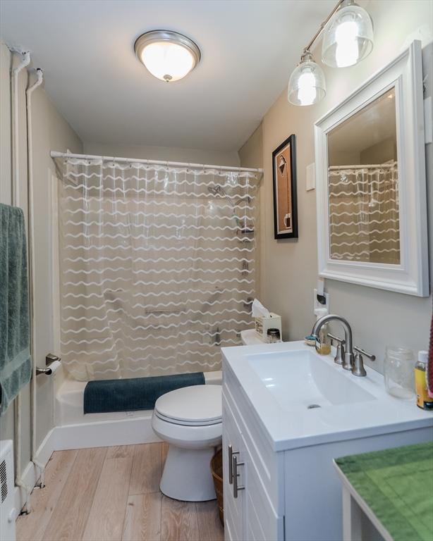 16 Fairfield Ave, Northampton, MA 01062 - full bath with vanity, wood finished floors, and toilet