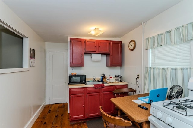 16 Fairfield Ave, Northampton, MA 01062 - kitchen featuring black microwave, gas range gas stove, dark wood-style flooring, light countertops, and dark brown cabinets