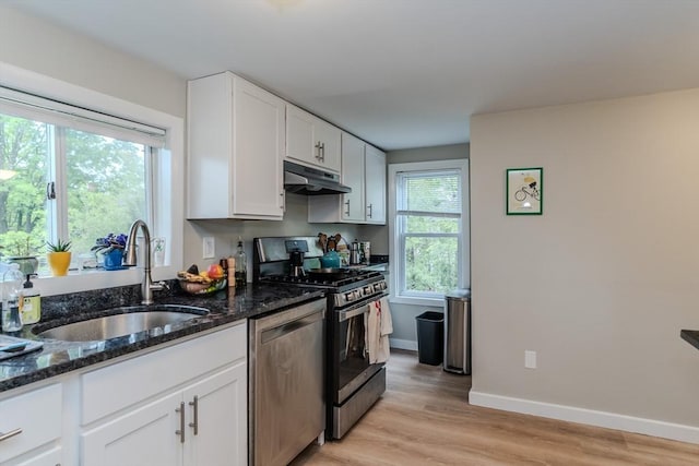 16 Fairfield Ave, Northampton, MA 01062 - kitchen with stainless steel appliances, a sink, under cabinet range hood, white cabinetry, and light wood finished floors