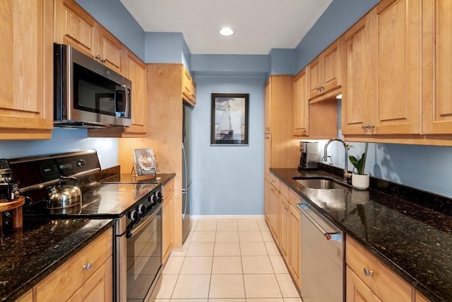 456 Belmont St Unit 21, Watertown, MA 02472 - kitchen featuring dark stone counters, light tile patterned flooring, a sink, and stainless steel appliances