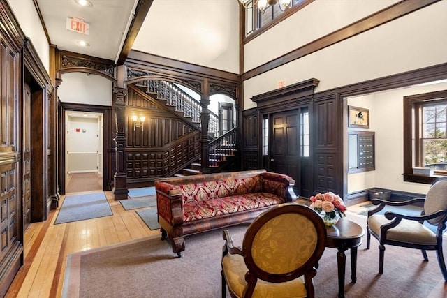 456 Belmont St Unit 21, Watertown, MA 02472 - sitting room with light wood-type flooring, recessed lighting, a towering ceiling, and stairs