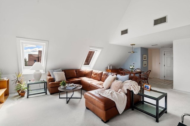 456 Belmont St Unit 21, Watertown, MA 02472 - living room featuring high vaulted ceiling, visible vents, and light colored carpet
