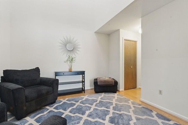 sitting room featuring baseboards and wood finished floors