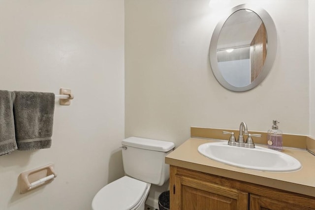 half bathroom with vanity and toilet