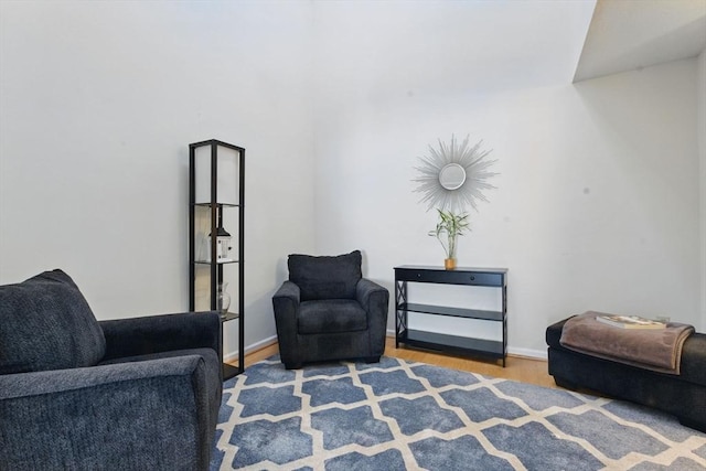 living area featuring baseboards and wood finished floors