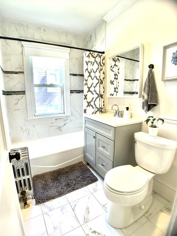 22-24 Ellison Ave Unit 1, Boston, MA 02126 - full bath featuring marble finish flooring, vanity, and shower / bath combo with shower curtain