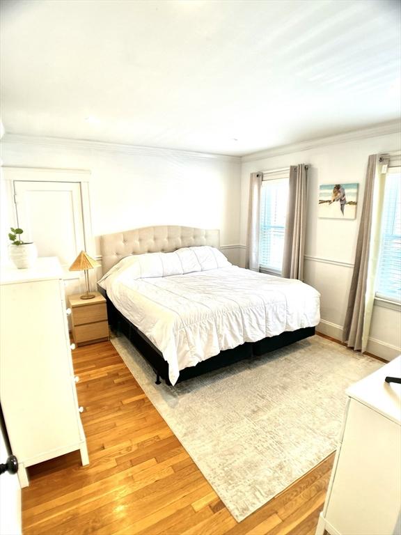 22-24 Ellison Ave Unit 1, Boston, MA 02126 - bedroom featuring light wood-type flooring and ornamental molding