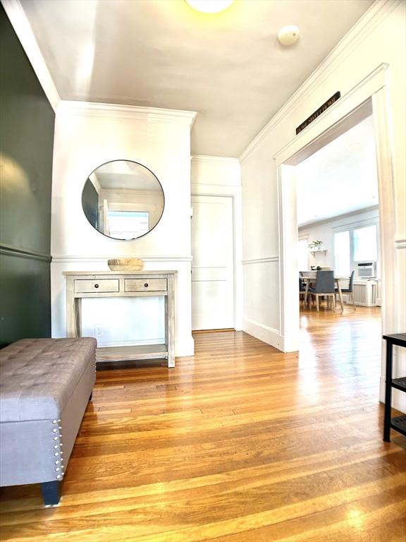 22-24 Ellison Ave Unit 1, Boston, MA 02126 - living room with light wood-style floors and ornamental molding