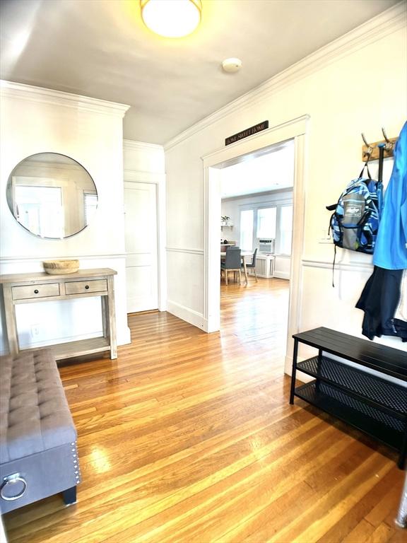 22-24 Ellison Ave Unit 1, Boston, MA 02126 - hallway featuring light wood-style flooring and ornamental molding