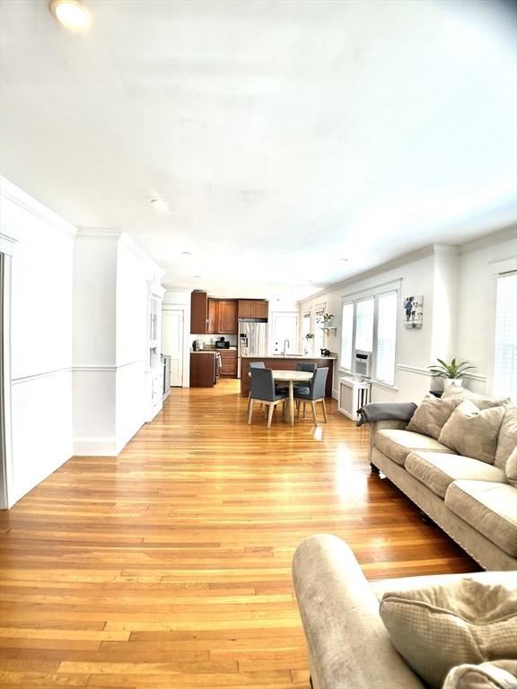 22-24 Ellison Ave Unit 1, Boston, MA 02126 - living area featuring crown molding and light wood-style flooring