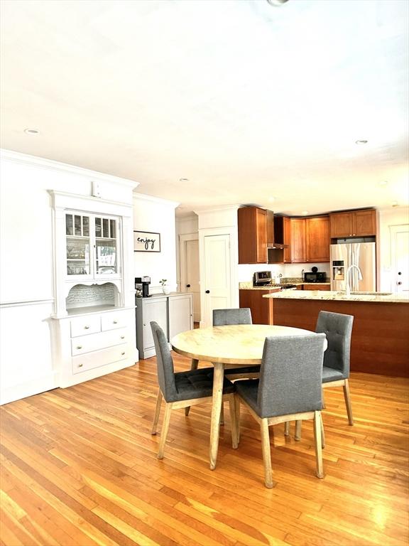 22-24 Ellison Ave Unit 1, Boston, MA 02126 - dining room with light wood-type flooring, ornamental molding, and recessed lighting