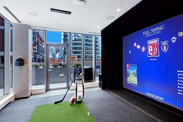 game room featuring a view of city, a textured ceiling, and floor to ceiling windows