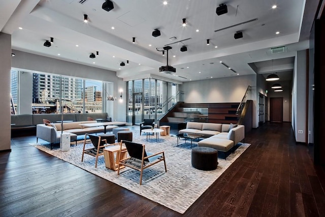 living area with visible vents, stairs, wood-type flooring, a tray ceiling, and recessed lighting
