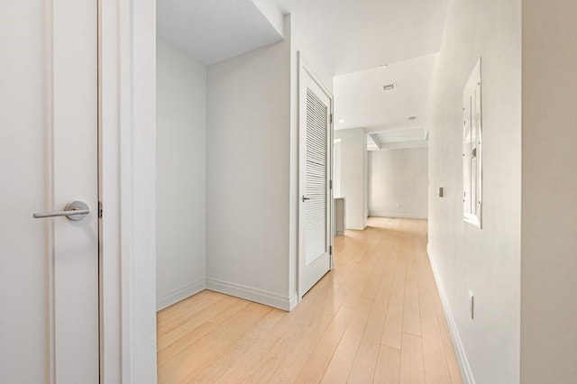 hallway with baseboards and wood finished floors