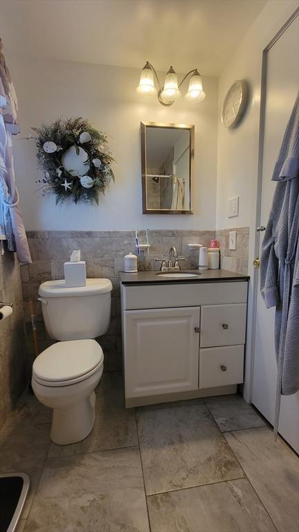1285 Pendleton Ave Unit 1285, Chicopee, MA 01022 - full bath featuring tile walls, vanity, and a wainscoted wall