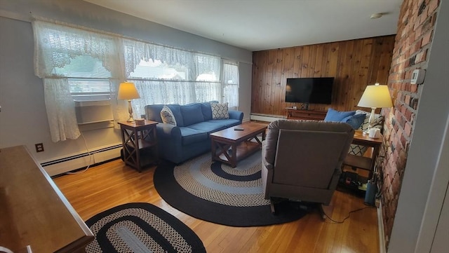 1285 Pendleton Ave Unit 1285, Chicopee, MA 01022 - living area with baseboard heating, wooden walls, wood finished floors, and an accent wall