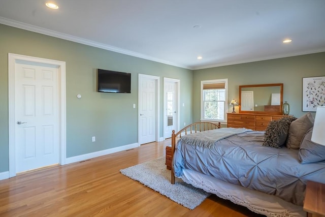 bedroom featuring crown molding and light wood-type flooring