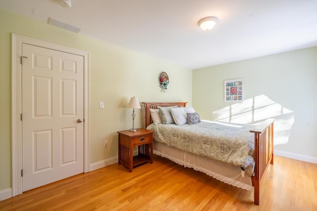 bedroom with hardwood / wood-style flooring