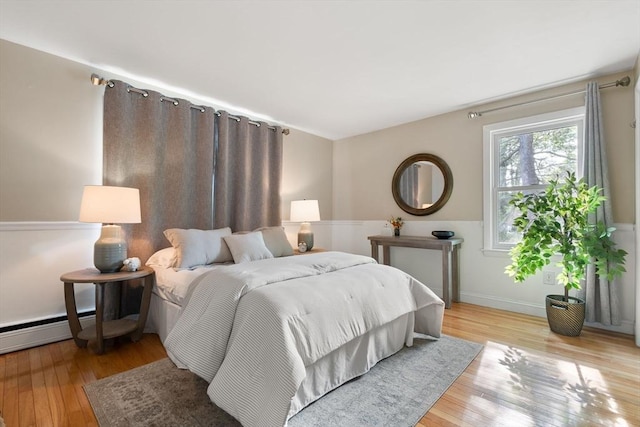 56 Beach St, Woburn, MA 01801 - bedroom featuring wood finished floors and a baseboard radiator
