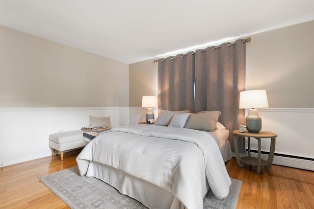 56 Beach St, Woburn, MA 01801 - bedroom featuring a baseboard radiator and wood finished floors