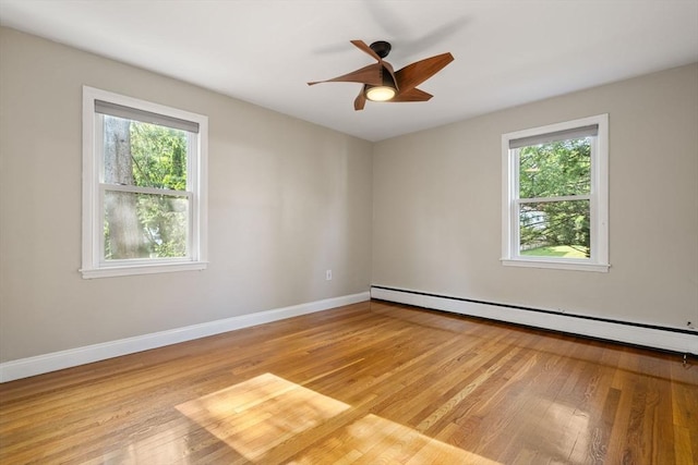 56 Beach St, Woburn, MA 01801 - empty room featuring baseboard heating, plenty of natural light, light wood finished floors, and a ceiling fan