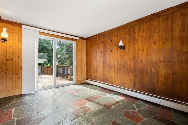 56 Beach St, Woburn, MA 01801 - spare room featuring stone floors, baseboard heating, and wood walls
