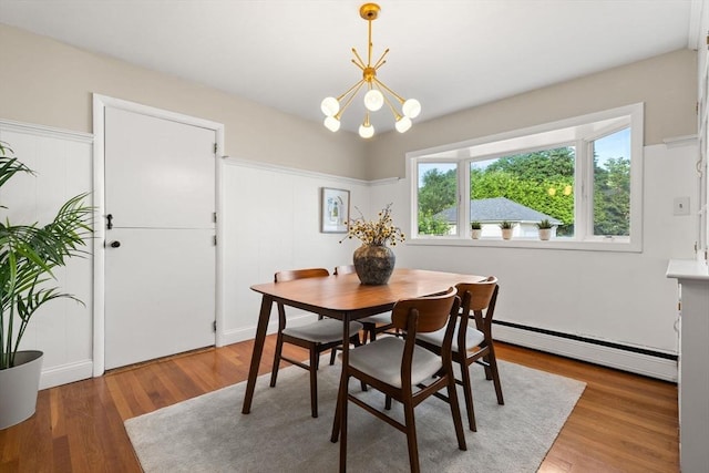 56 Beach St, Woburn, MA 01801 - dining space featuring a baseboard radiator, a chandelier, and wood finished floors