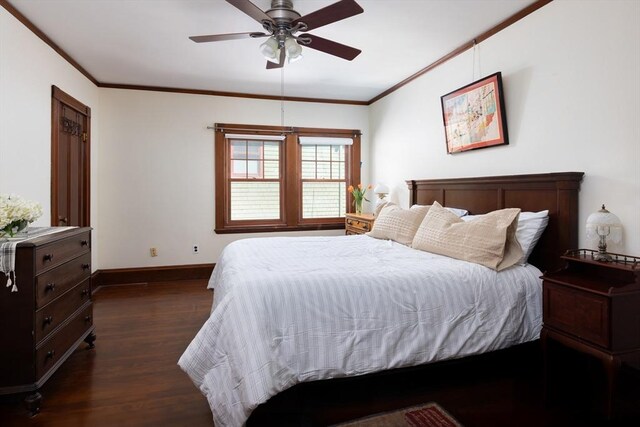 bedroom with dark wood-style floors, baseboards, ornamental molding, and a ceiling fan