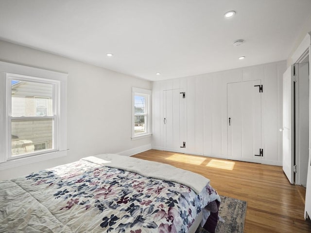 bedroom featuring multiple windows and wood-type flooring