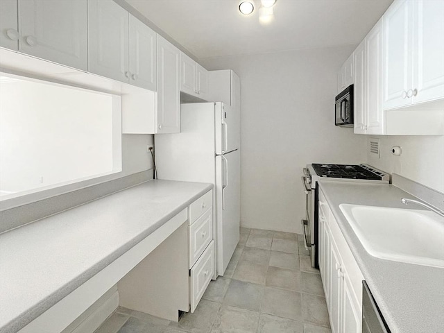 kitchen featuring stainless steel appliances, white cabinets, and sink