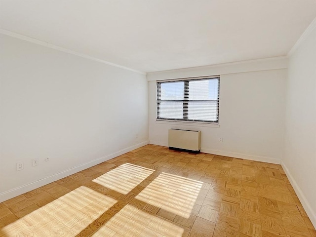 empty room featuring light parquet flooring and ornamental molding