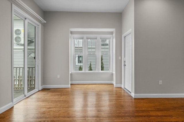 63 Perrin St, Boston, MA 02119 - empty room with wood finished floors, healthy amount of natural light, and baseboards