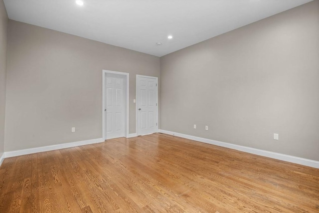 63 Perrin St, Boston, MA 02119 - empty room with baseboards, recessed lighting, and light wood-style flooring