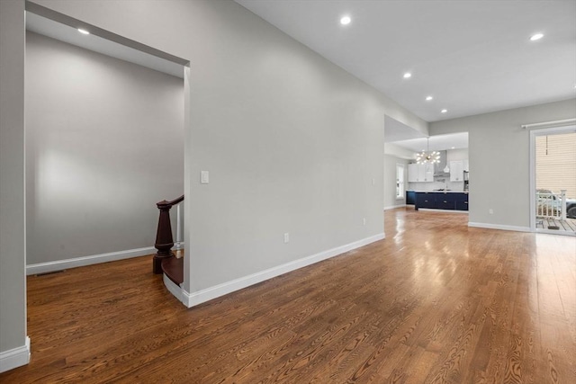63 Perrin St, Boston, MA 02119 - unfurnished living room featuring a chandelier, wood finished floors, recessed lighting, and baseboards