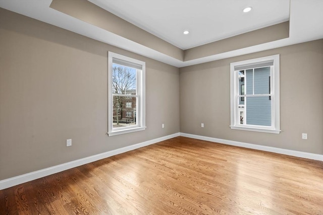 63 Perrin St, Boston, MA 02119 - empty room with baseboards, wood finished floors, a tray ceiling, and recessed lighting