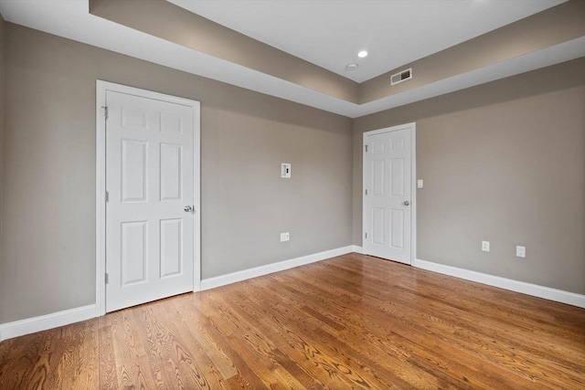 63 Perrin St, Boston, MA 02119 - empty room featuring baseboards, wood finished floors, a tray ceiling, and recessed lighting
