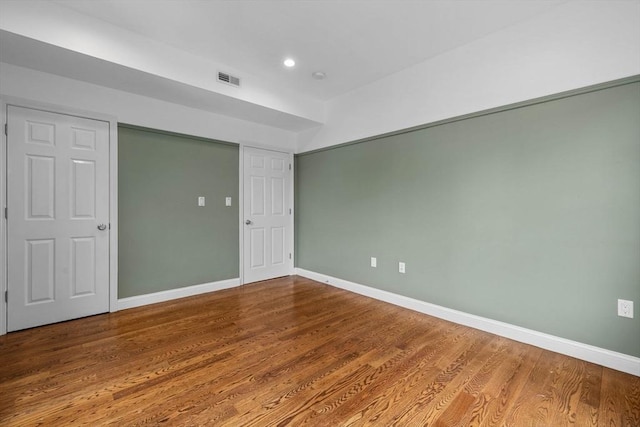 63 Perrin St, Boston, MA 02119 - unfurnished bedroom featuring baseboards, wood finished floors, and recessed lighting