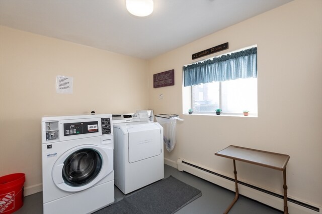 washroom featuring baseboard heating and washing machine and clothes dryer