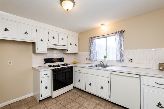 kitchen featuring white appliances, tasteful backsplash, white cabinetry, and sink