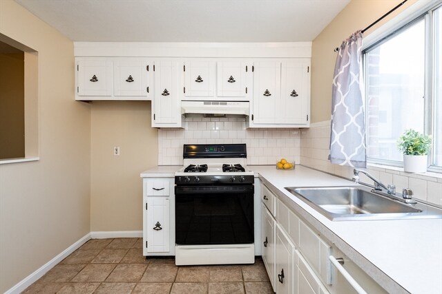 kitchen featuring a wealth of natural light, sink, white range with gas stovetop, and ventilation hood